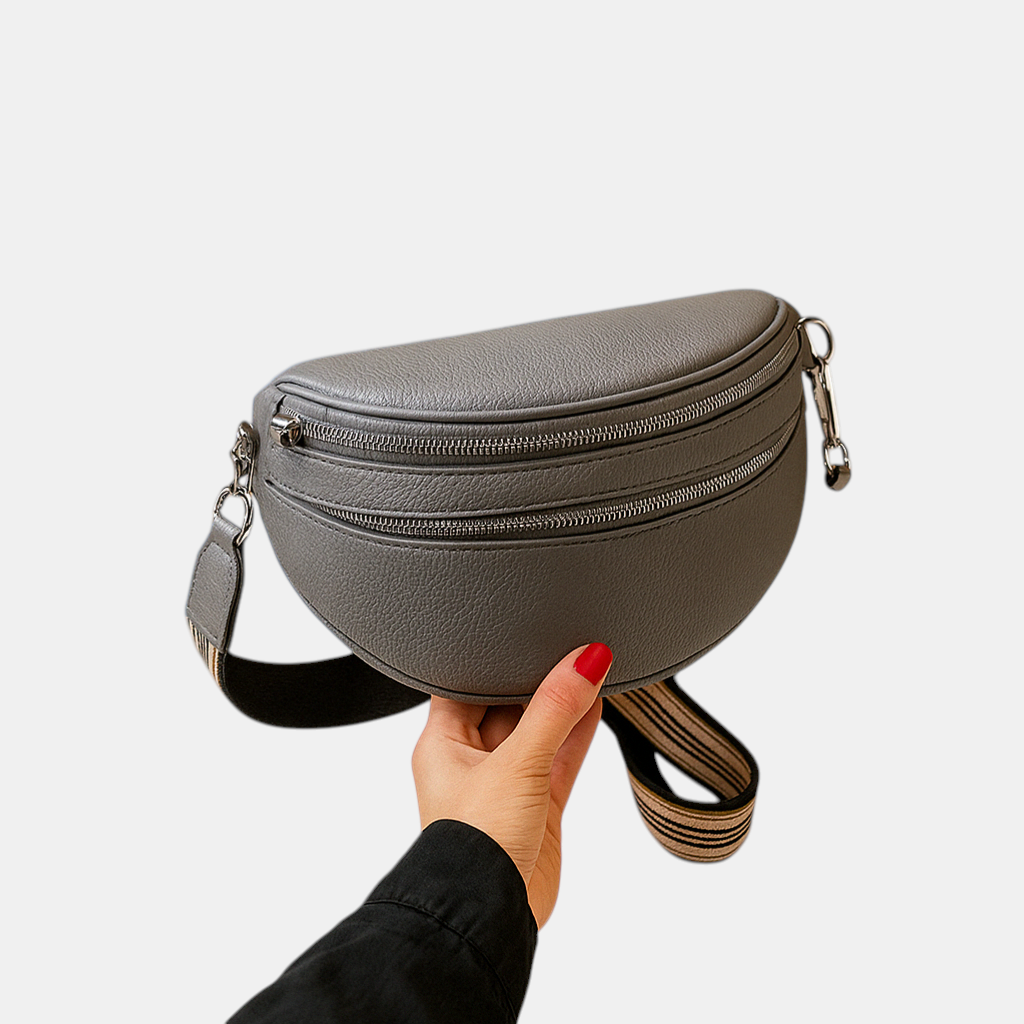 Close-up van de dubbele rits op een crossbodytas, luxe detail