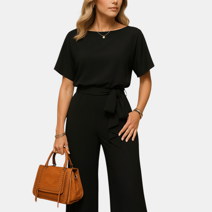 Chique dames jumpsuit in zwart, beige of groen met getailleerde pasvorm en losvallende mouwen, ideaal voor formele en stijlvolle gelegenheden.
