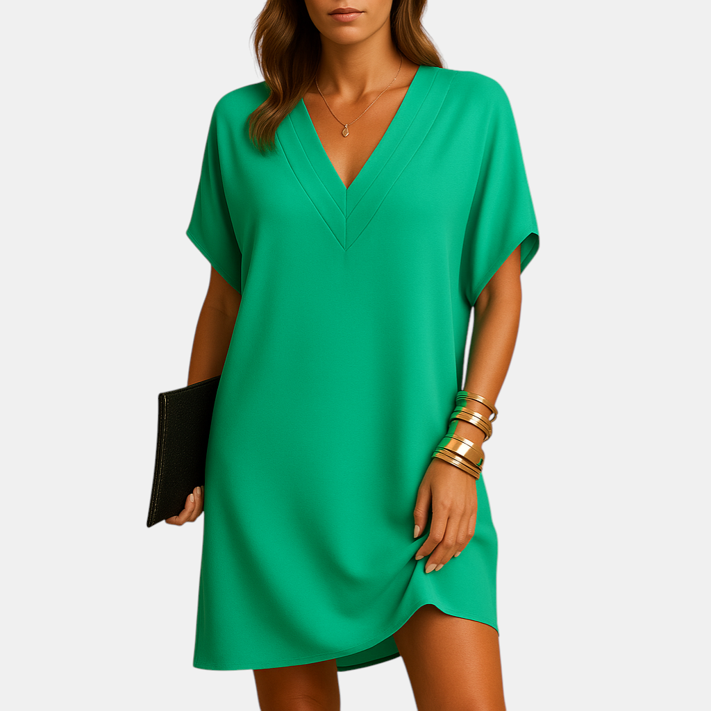 Elegante damesjurk met V-hals en splitmouwen, knielang model in zachte stof, ideaal voor casual en feestelijke gelegenheden.