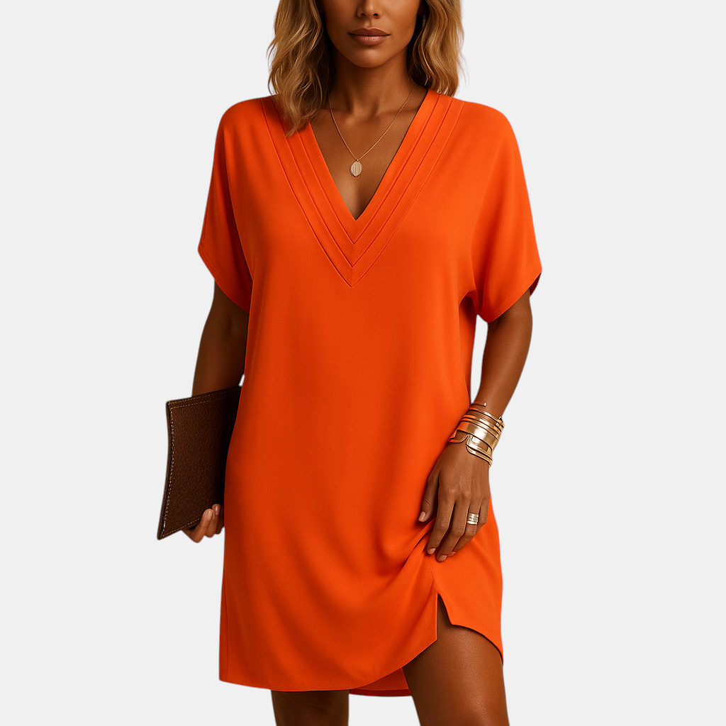 Elegante damesjurk met V-hals en splitmouwen, knielang model in zachte stof, ideaal voor casual en feestelijke gelegenheden.
