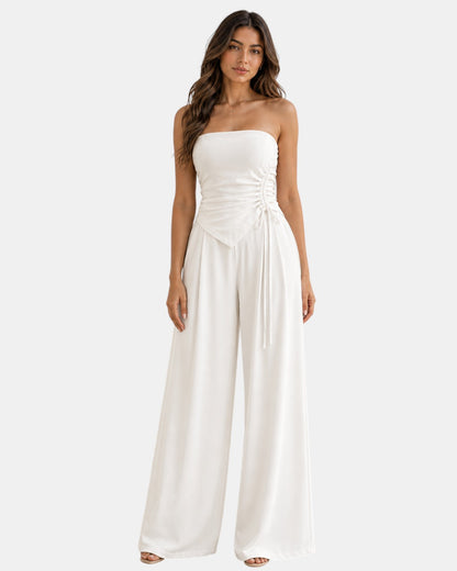 Luxen-Amsterdam witte strapless top met ruches en strikdetail, gecombineerd met wijde pijpen broek.
