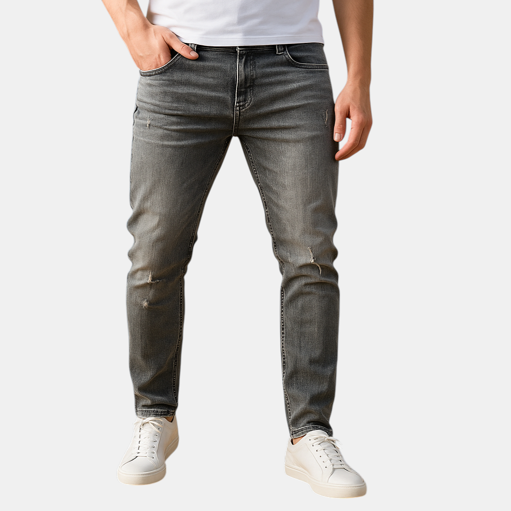 Slim fit herenjeans in blauw of grijs met gescheurd detail, gemaakt van duurzaam stretchdenim voor een stoere en comfortabele urban look.